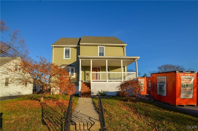 view of front of property with a porch and a front yard