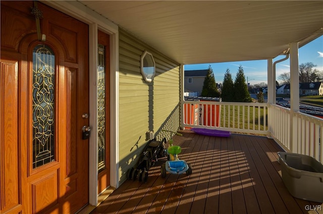 wooden terrace featuring covered porch