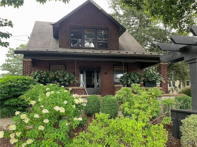 rear view of house featuring a porch