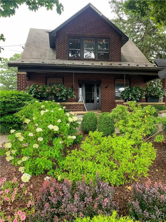 back of property with covered porch