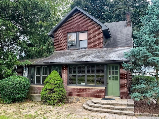 back of property with a sunroom