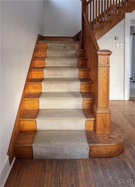 stairs with wood-type flooring