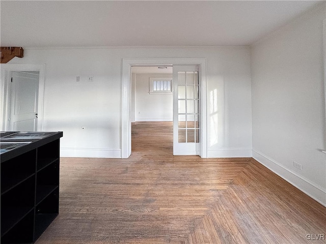 unfurnished room with parquet flooring and french doors