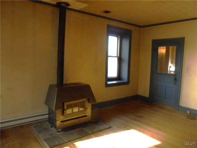 unfurnished living room featuring a baseboard radiator and hardwood / wood-style flooring