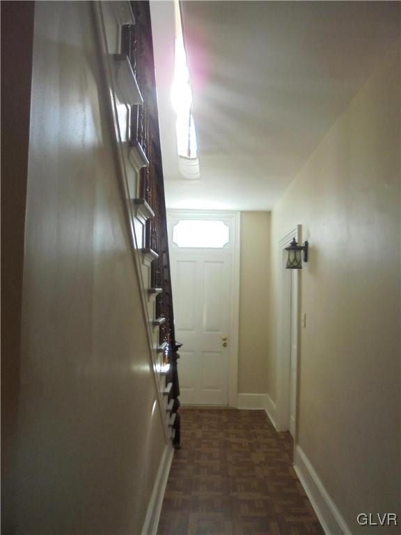 entryway with dark parquet floors