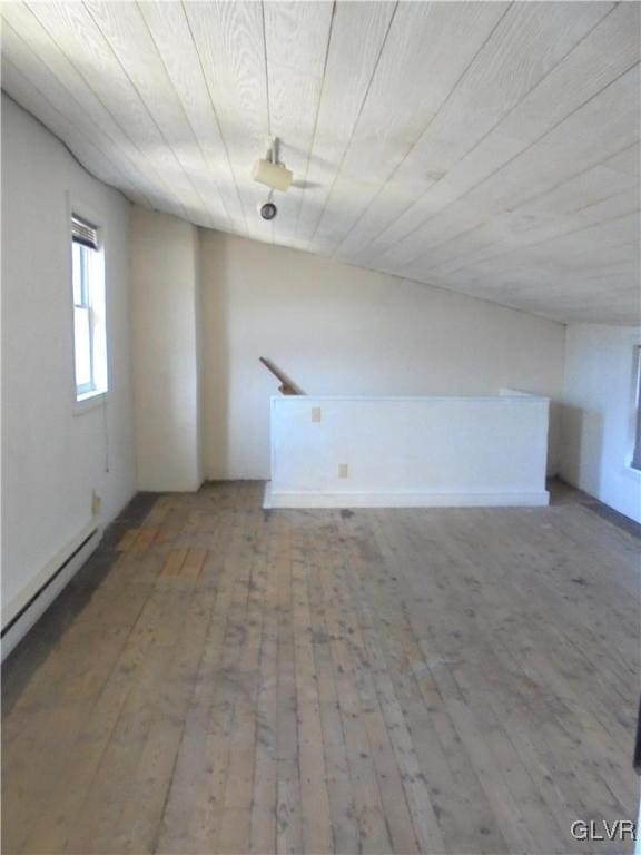 bonus room with wood ceiling, a baseboard radiator, and hardwood / wood-style flooring