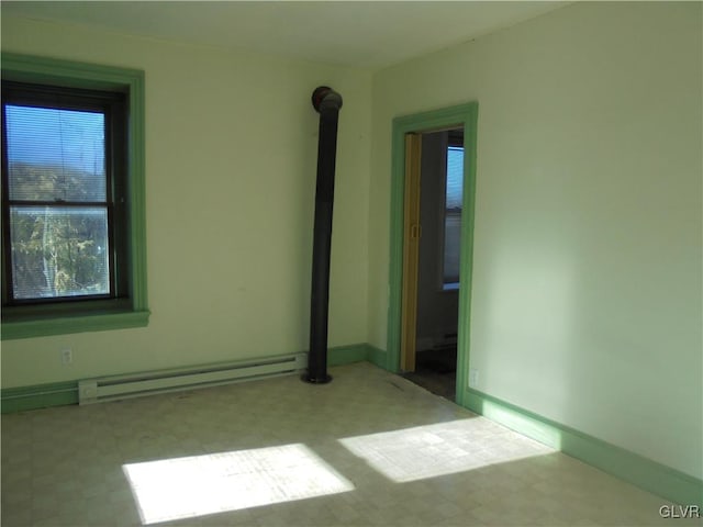 empty room featuring a baseboard heating unit