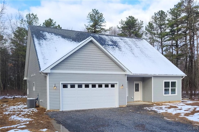 view of front facade featuring central AC and a garage