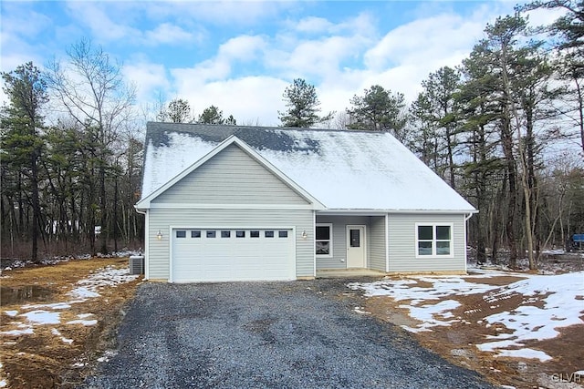 view of front of home with a garage and central AC