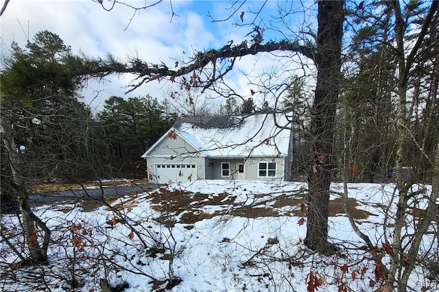 view of snow covered exterior with a garage