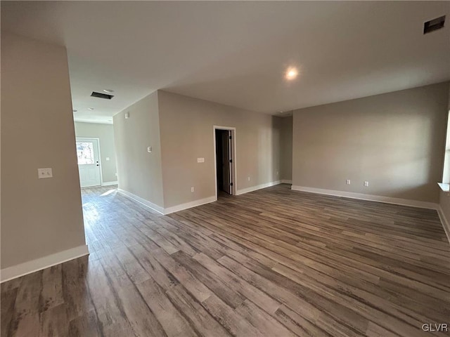 unfurnished room with wood-type flooring