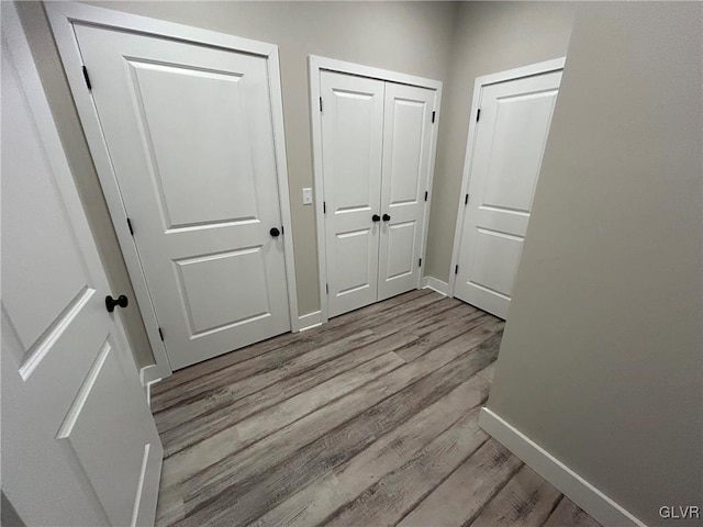 corridor with light hardwood / wood-style floors