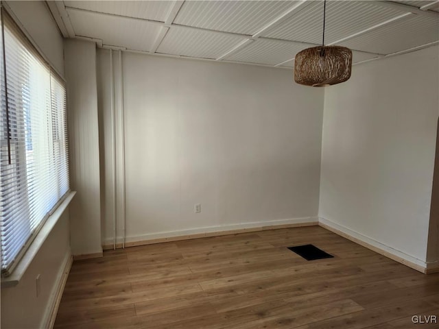 unfurnished room with hardwood / wood-style floors