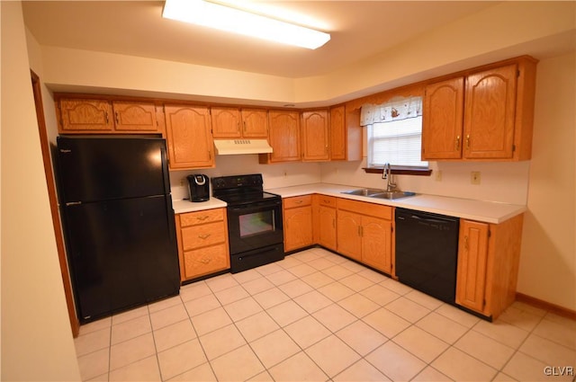 kitchen featuring black appliances, light tile patterned floors, and sink