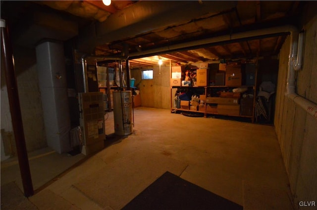 basement featuring electric panel, heating unit, and water heater