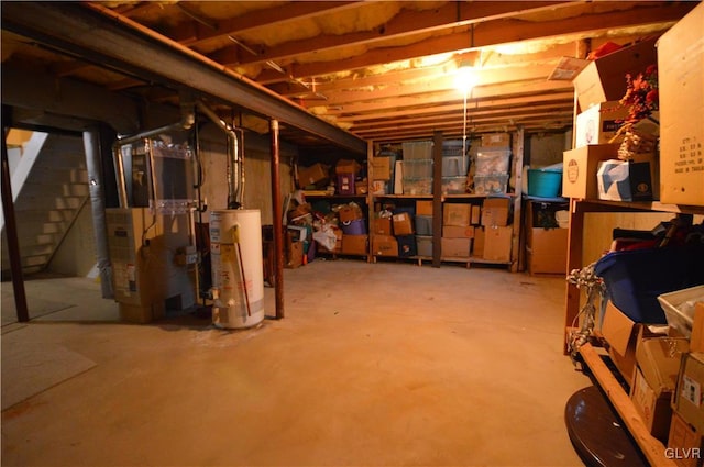 basement featuring gas water heater and heating unit