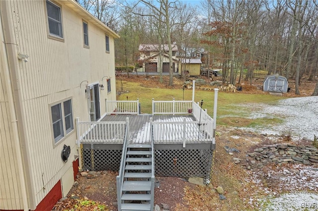 deck with a shed and a yard