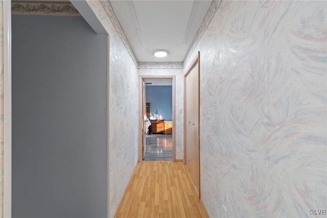 hallway with light hardwood / wood-style floors