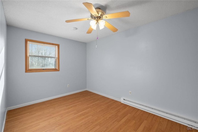 unfurnished room with a textured ceiling, ceiling fan, light hardwood / wood-style flooring, and a baseboard heating unit