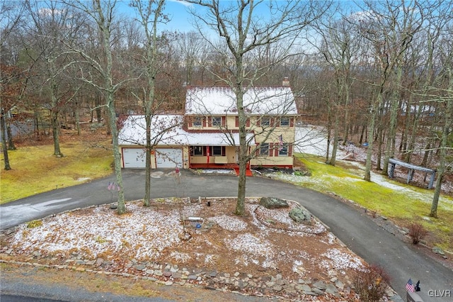 view of front of home featuring a garage and a front yard