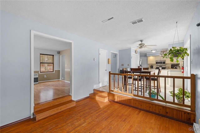 interior space with a textured ceiling and hardwood / wood-style flooring