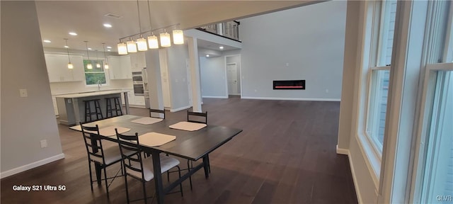 dining area with dark hardwood / wood-style flooring