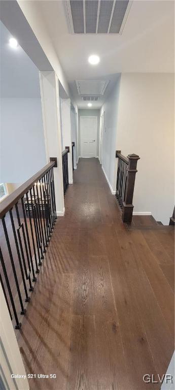 corridor with dark hardwood / wood-style flooring