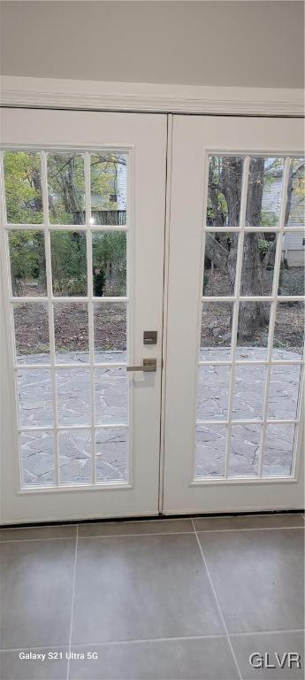 doorway to outside with tile patterned floors