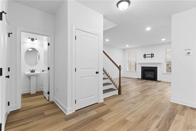 hallway with light hardwood / wood-style floors