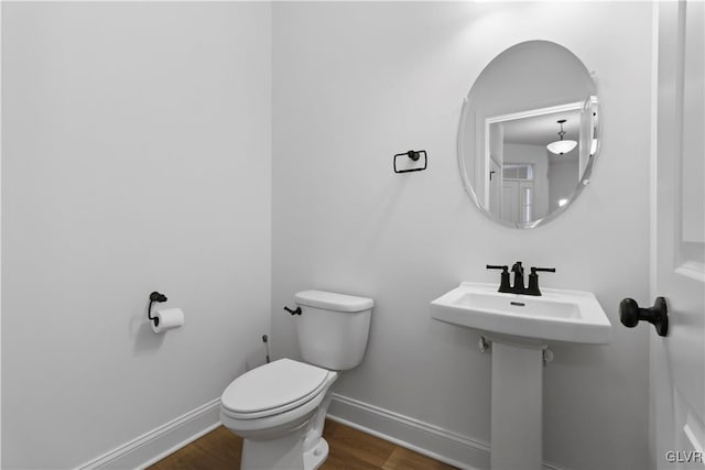 bathroom with wood-type flooring and toilet