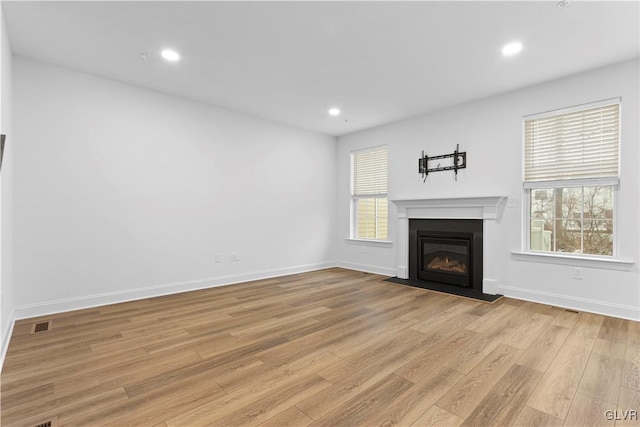 unfurnished living room with light hardwood / wood-style floors