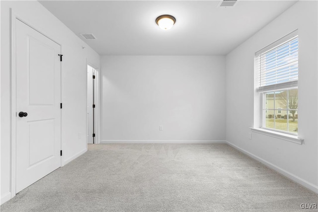 unfurnished room with light colored carpet and a healthy amount of sunlight