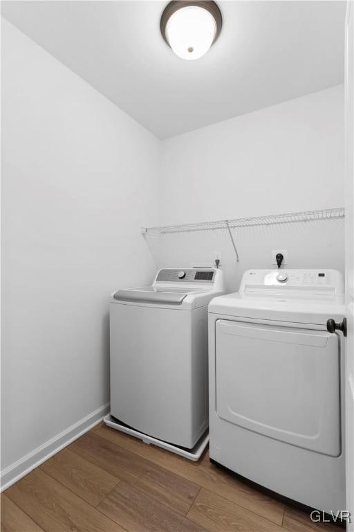 washroom featuring independent washer and dryer and wood-type flooring