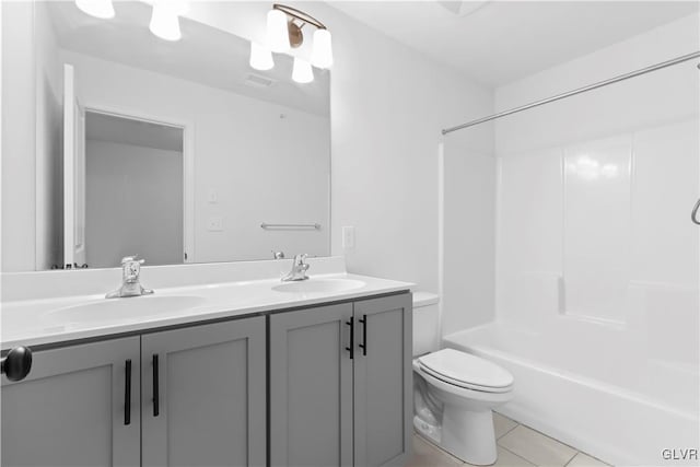 full bathroom featuring tile patterned floors, bathing tub / shower combination, vanity, and toilet