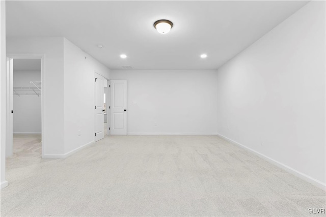 spare room featuring light carpet