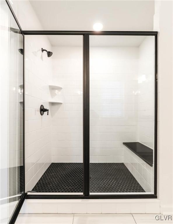 bathroom with a shower with shower door