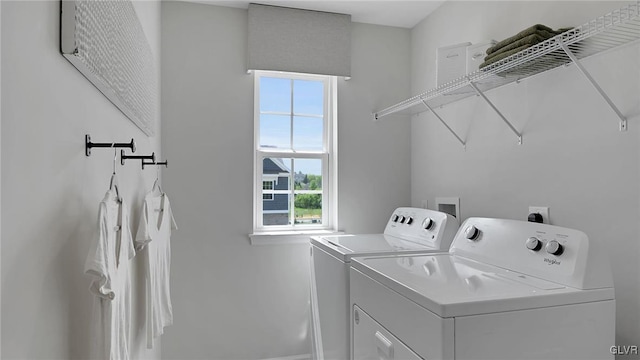 clothes washing area with washing machine and dryer