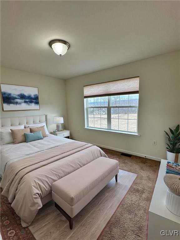 bedroom featuring visible vents, carpet, and baseboards