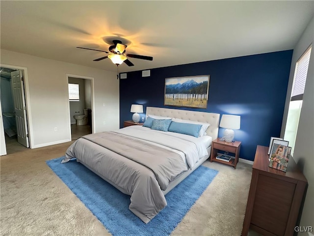 bedroom with ensuite bathroom, a ceiling fan, baseboards, and carpet floors