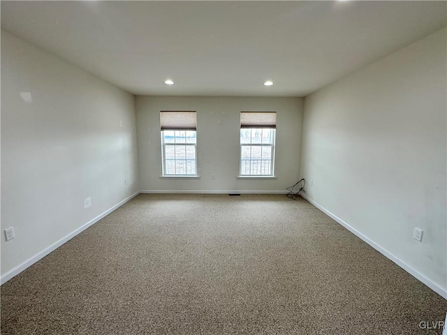 unfurnished room with recessed lighting, baseboards, and carpet