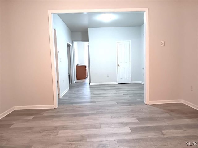 corridor with hardwood / wood-style floors