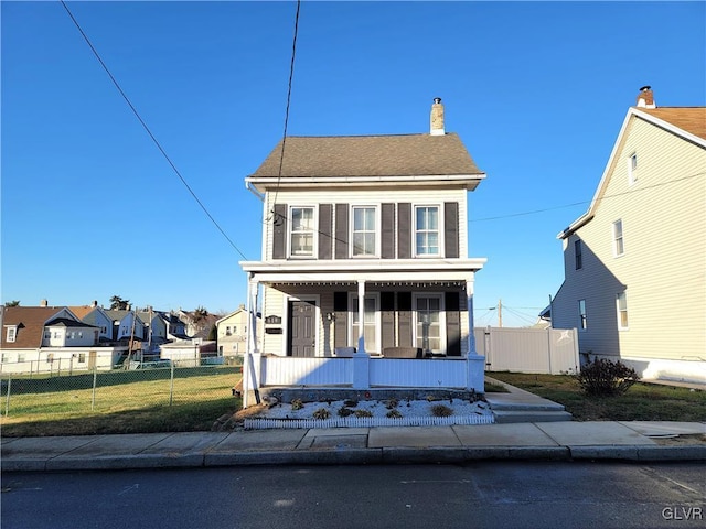 view of front of home featuring a front yard and a porch