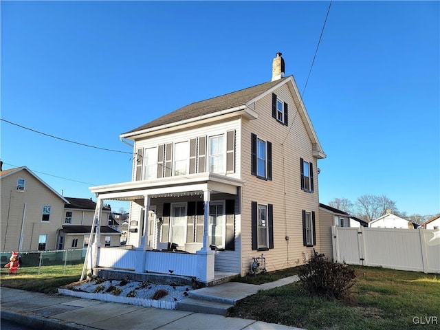 view of front of property with a porch and a front lawn