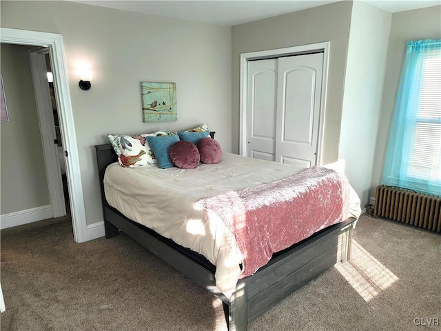 carpeted bedroom with radiator and a closet