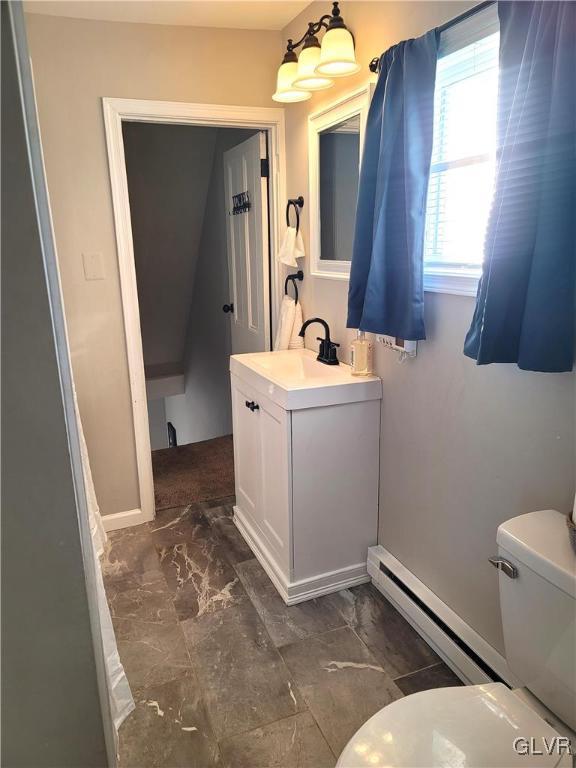 bathroom with vanity, a baseboard radiator, and toilet