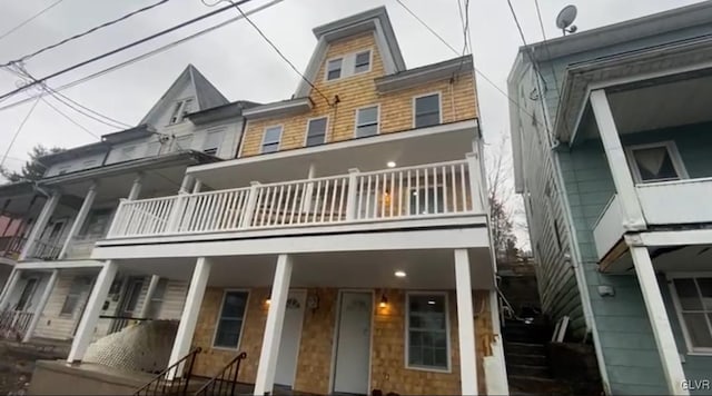 rear view of property featuring a balcony