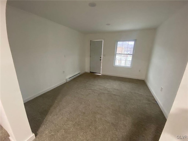 carpeted empty room featuring a baseboard radiator