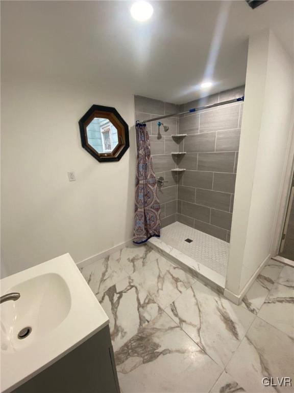 bathroom featuring vanity and a shower with shower curtain