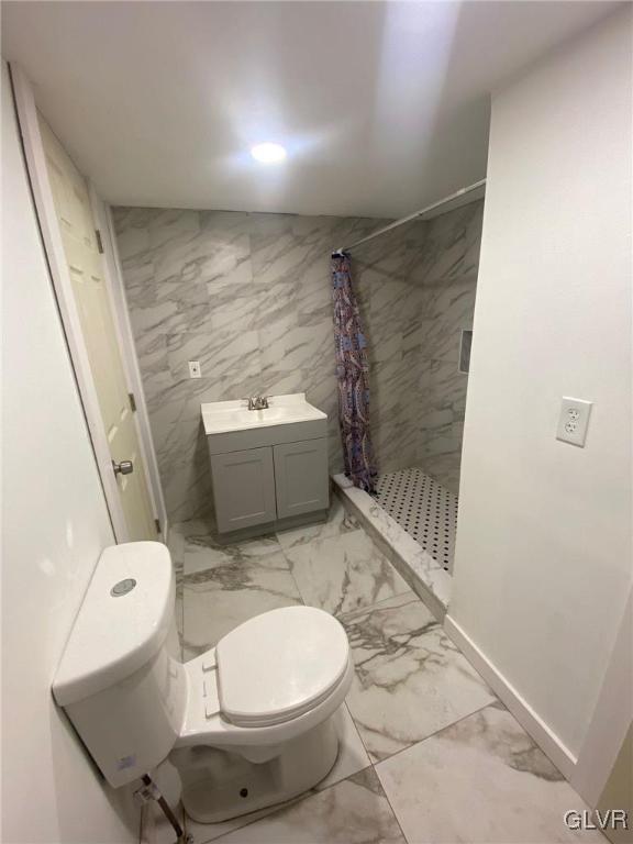 bathroom featuring vanity, tile walls, toilet, and a shower with shower curtain