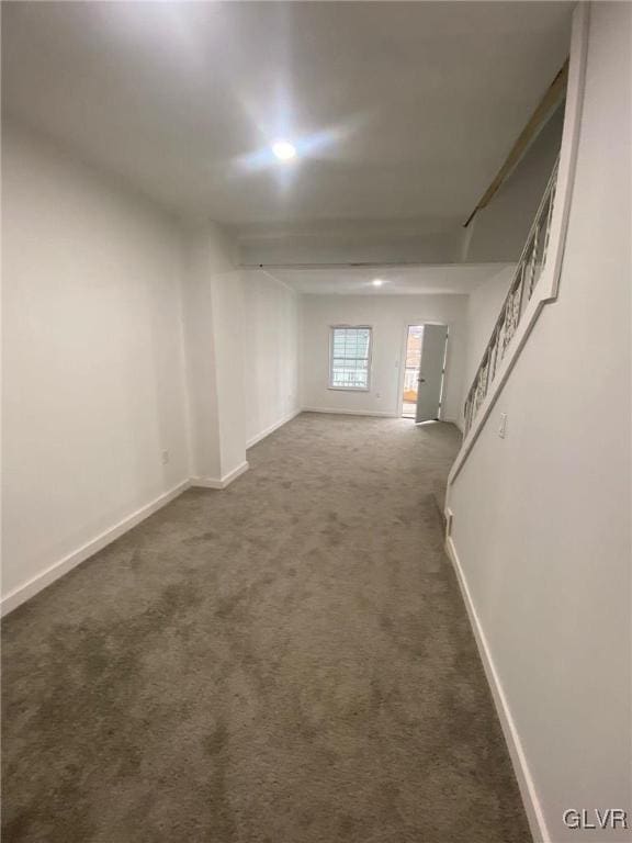 unfurnished room featuring dark colored carpet